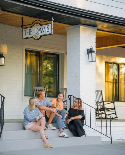 Family of four on the front steps of a Casago cabin